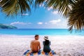 Tropical white beach at Praslin island Seychelles, happy Young couple man and woman on the beach Royalty Free Stock Photo