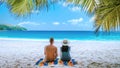 Tropical white beach at Praslin island Seychelles, happy Young couple man and woman on the beach Royalty Free Stock Photo