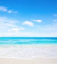 Tropical white sand beach and blue sky at summer sunny day. Idyllic tropical beach scene Royalty Free Stock Photo