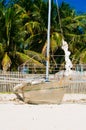 Tropical white sand beach with green palm trees and parked fishing boats in the sand. Exotic island paradise Royalty Free Stock Photo