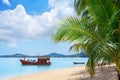 Tropical white sand beach landscape, turquoise sea water, blue sky, clouds, green palm, boat, summer on Samui island, Thailand Royalty Free Stock Photo