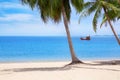 Tropical white sand beach landscape, turquoise sea water, blue sky, clouds, green palm tree leaves, boat, sunny day, nobody, relax Royalty Free Stock Photo