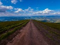 Tropped mountain road leading down to the plain. A good place to go through the tourist routes Royalty Free Stock Photo