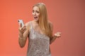 Troubled concerned arrogant young blond woman complaining yelling smartphone cannot call friend no signal holding