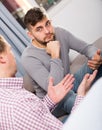 Troubled man talking with friend on sofa Royalty Free Stock Photo