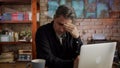 Troubled mature man working at home office with laptop Royalty Free Stock Photo