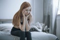 Troubled teenager sitting on a bed Royalty Free Stock Photo