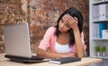 Troubled woman sitting at his desk with a laptop Royalty Free Stock Photo