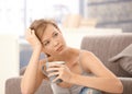 Troubled woman thinking with tea in hand Royalty Free Stock Photo