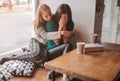 Troubled young girl comforted by her friend. Woman supporting the girl