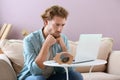 Troubled young man counting earnings at home Royalty Free Stock Photo