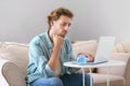 Troubled young man counting earnings at home Royalty Free Stock Photo