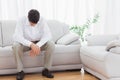 Troubled young man sitting on sofa Royalty Free Stock Photo