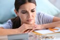 Troubled young woman thinking about bills while sitting at table Royalty Free Stock Photo