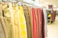 Trousers on hangers - clothing rental or reselling concept. Thrist shopping or seconhand store concept. Clothes stall