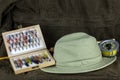 Fly Fishing Rod with Fly Box and Hat on Outdoor Coat Royalty Free Stock Photo