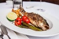 Trout grill with tomatoes,peppers,lemon and fried potatoes Royalty Free Stock Photo