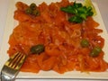 Trout sliced in small slices on a plate