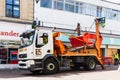 Trowbridge Wiltshire June 28th 2019 A truck driver using the controls to life a skip of building waste onto the lorry