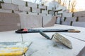 Trowel, a couple of saws are on the foamed concrete block during the building house on the construction site