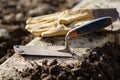 Trowel and protective gloves Royalty Free Stock Photo