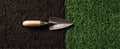 The trowel resting between fresh soil and vibrant green grass..AI generated image Royalty Free Stock Photo