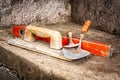 Trowels and other masonry tools on a concrete wall Royalty Free Stock Photo