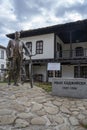 TROYAN, BULGARIA - March 2, 2020:StatuÃÂµ of man with bycicle in front of traditional Bulgarian house near the Museum of Folk Arts