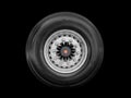 Truck alloy wheel and tyre isolated on black background. New alloy wheel with tire. Heavy truck alloy rim isolated. Commercial Royalty Free Stock Photo