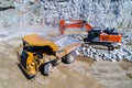 Truck and bulldozer working in the stone mine