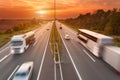 Truck and bus on the motorway at sunset Royalty Free Stock Photo