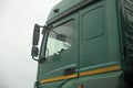 Truck cab on side. Green truck body. Transport details. Rear-view mirror of car Royalty Free Stock Photo