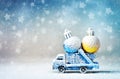 Truck car carries Cristmas ball for Christmas trees. Royalty Free Stock Photo