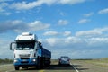 Truck and car on a long road to the sky horizon Royalty Free Stock Photo