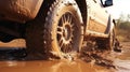 Truck car spins its wheels in the mud closeup