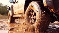 Truck car spins its wheels in the mud closeup