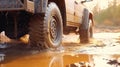 Truck car spins its wheels in the mud closeup