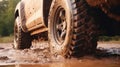 Truck car spins its wheels in the mud closeup