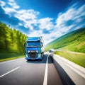 Truck with cargo driving on the road with green nature and blue sky motion blur