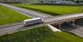 Truck with Cargo Semi Trailer Moving on Road in Direction. Highway intersection junction. Aerial Top View Royalty Free Stock Photo