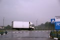 A truck is carrying cargo along the highway