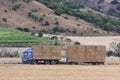 Truck carrying hay in his body. Making hay for the winter