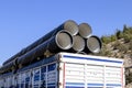 Truck carrying large pipes, close-up. transport.
