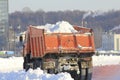 Truck carrying the snow on the street in winter, cleaning of streets