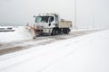 Truck cleaning  winter road covered with snow Royalty Free Stock Photo