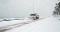 Truck cleaning  winter road covered with snow Royalty Free Stock Photo