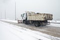 Truck cleaning winter road covered with snow Royalty Free Stock Photo