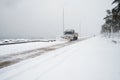 Truck cleaning  winter road covered with snow Royalty Free Stock Photo