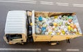 Truck for the collection of organic waste. Recycling separate waste collection. Many bags with organic remains of food