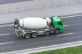 Truck with concrete mixer truck driving on the highway